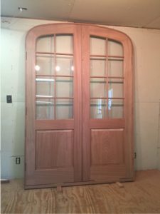 Arched top double mahogany wood entry door unit