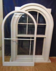 Historical reproduction arch top custom wood window unit.